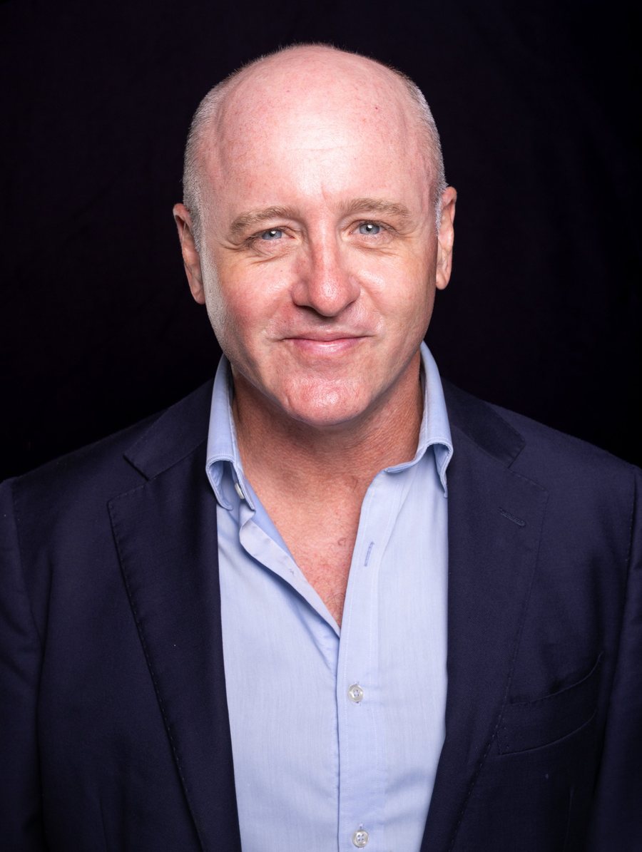 Dave Eastgate, corporate MC and event host, in a navy suit jacket